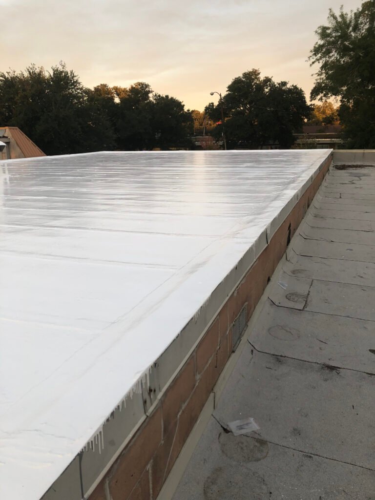 Restored industrial metal roof in Arkansas with a newly applied white reflective roof coating system