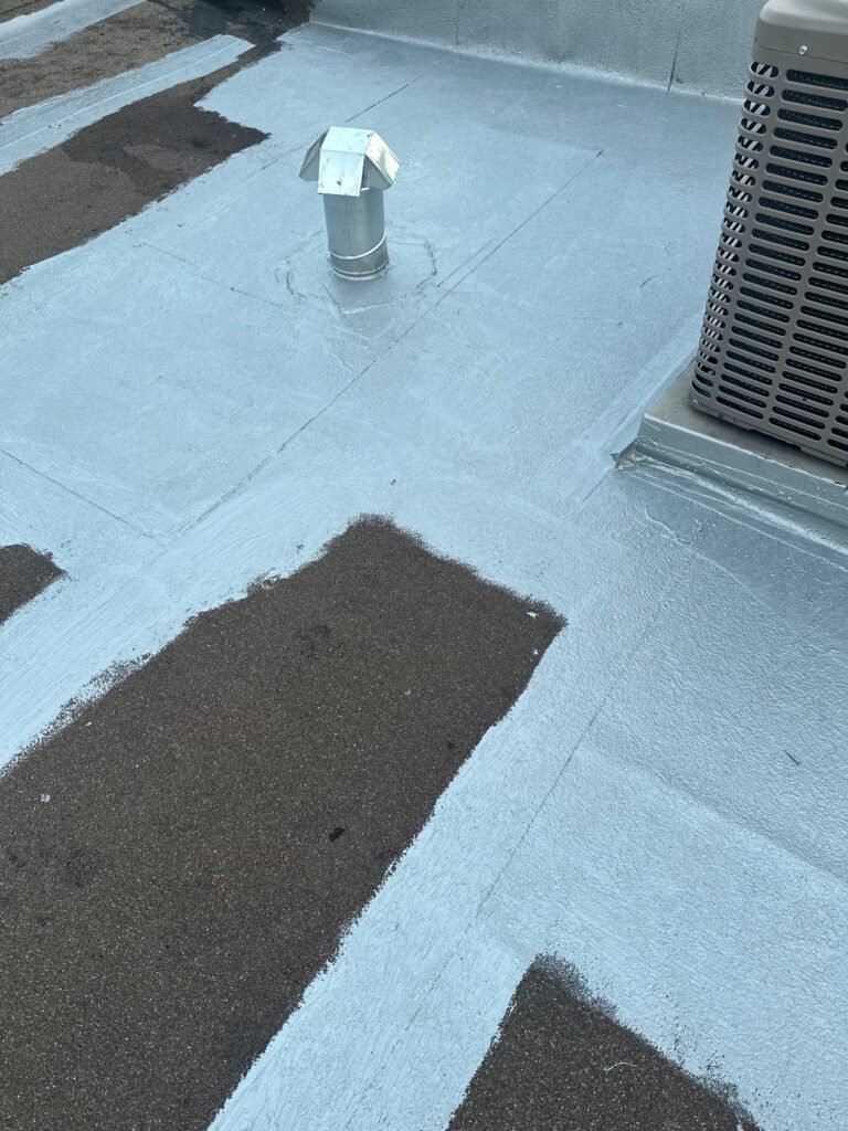 Commercial roof coating restoration around rooftop equipment and penetrations