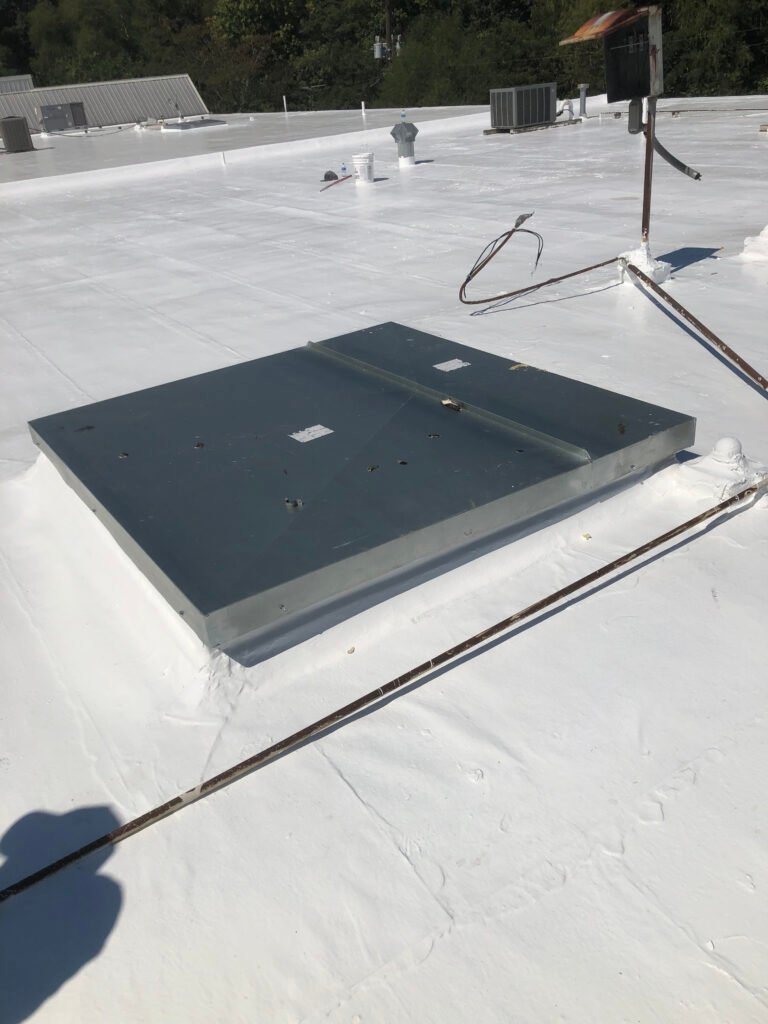 Restored commercial roof with sealed rooftop equipment and penetrations