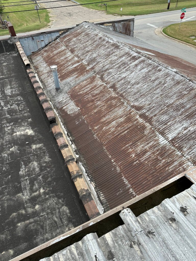 Deteriorated commercial metal roof before restoration and protective coating